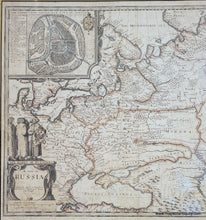 Load image into Gallery viewer, Framed antique map of Russia with decorative elements, slightly faded original color in red, orange, blue, yellow. Framing is black and gold.