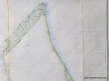 Load image into Gallery viewer, Close-up of part of the coast survey chart of Florida, 1860, showing the east coast and a table of latitudes and longitudes. Light green color along the coast and light blue in the water along the coast.