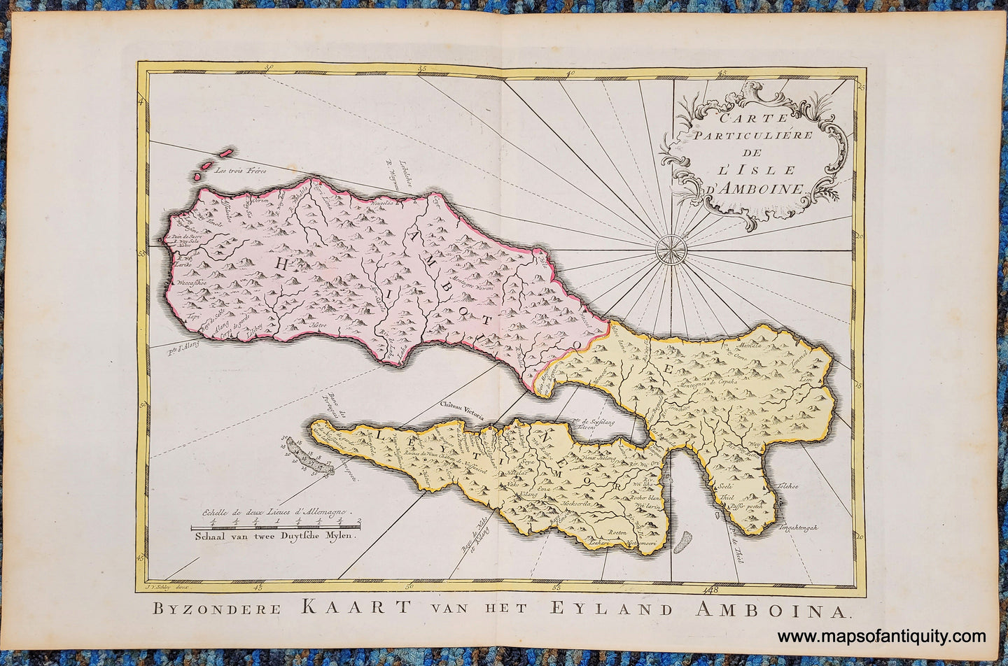 Antique map with hand-coloring in tones of pink and yellow. shows Ambon Island with mountains and compass rose