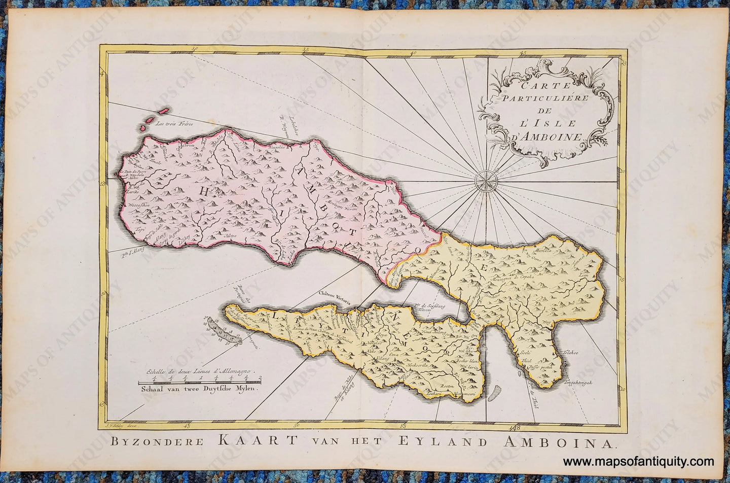 Antique map with hand-coloring in tones of pink and yellow. shows Ambon Island with mountains and compass rose