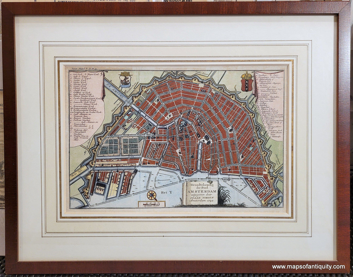 Antique map of the city of Amsterdam with vibrant colors of red, blue, green and yellow. North is oriented to the lower right. Genuine-Antique-Map-Amsterdam-Grondtekening-der-Stad-Amsterdam-uitgegeven-door-Isaak-Tirion-1742-Tirion-Maps-Of-Antiquity