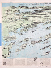 Load image into Gallery viewer, A vintage map 'Bird's Eye View of Casco Bay, Portland, Maine, and Surroundings,' showing illustrated coastlines, islands, and water in pale blue, green, and beige tones, with printed text panels along the bottom.
