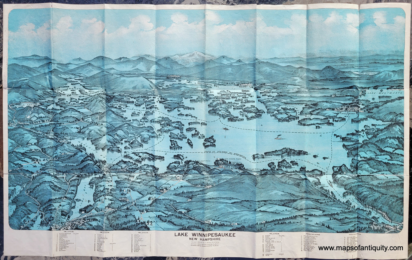 Antique Bird's-eye view map of lake Winnipesaukee in New Hampshire with the White Mountains in the distance. Chromolithograph with blue coloring.