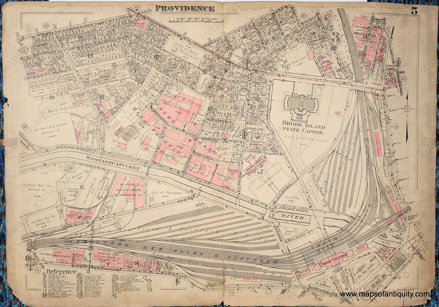 Antique plat map of part of the city of Providence. Light tan background with darker edges of the paper. Some of the buildingds are pink, which means they are made of brick.