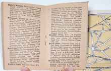 Load image into Gallery viewer, Antique map and travel booklet with information about places such as Parke&#39;s Museum, Houses of Parliament, Patent Office, etc. held open by a hand
